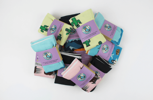 Pile of Scrubcare Footwear's nursing socks in various colours.