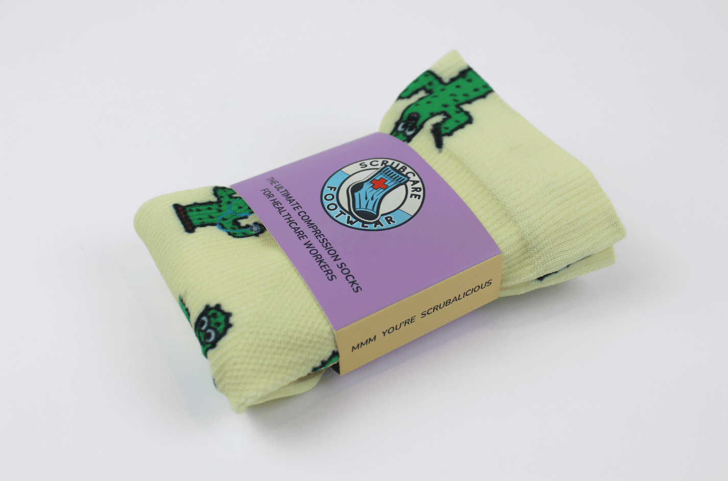 Cactus party compression socks for nurses in packaging viewed from the front.