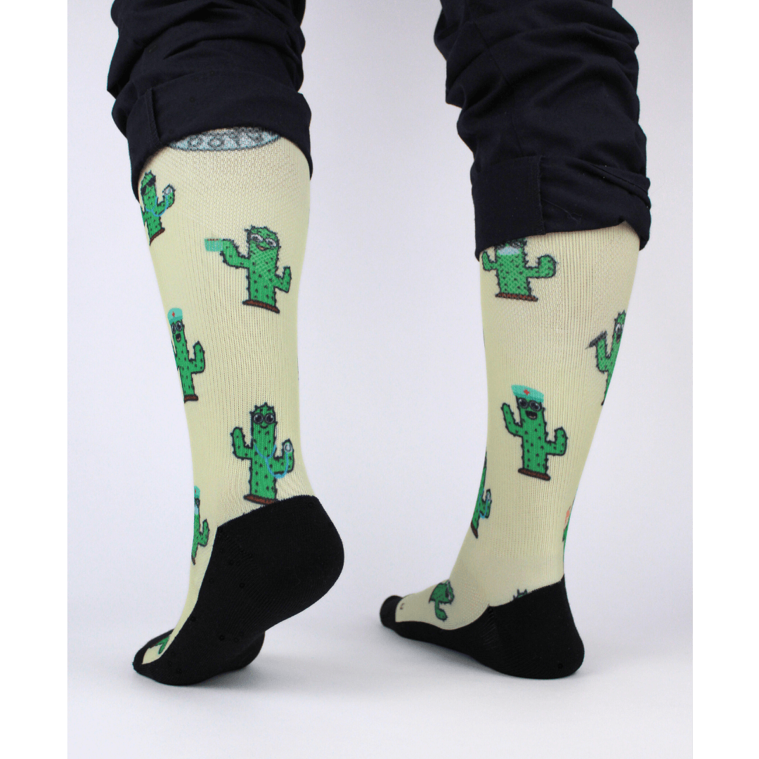 Compression socks for nurses with a cactus design, rear view of socks showing padding in the heel.