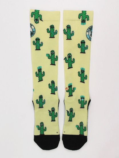 Compression socks for nurses with a cactus design, socks lying flat and facing up.